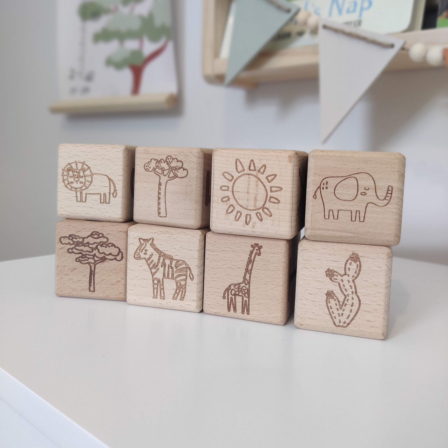 Solid wooden blocks with engraved safari animals stacked together