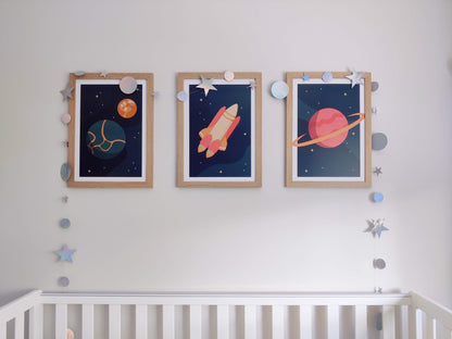 Three posters with matching space-themed artwork hanging on a child's bedroom wall