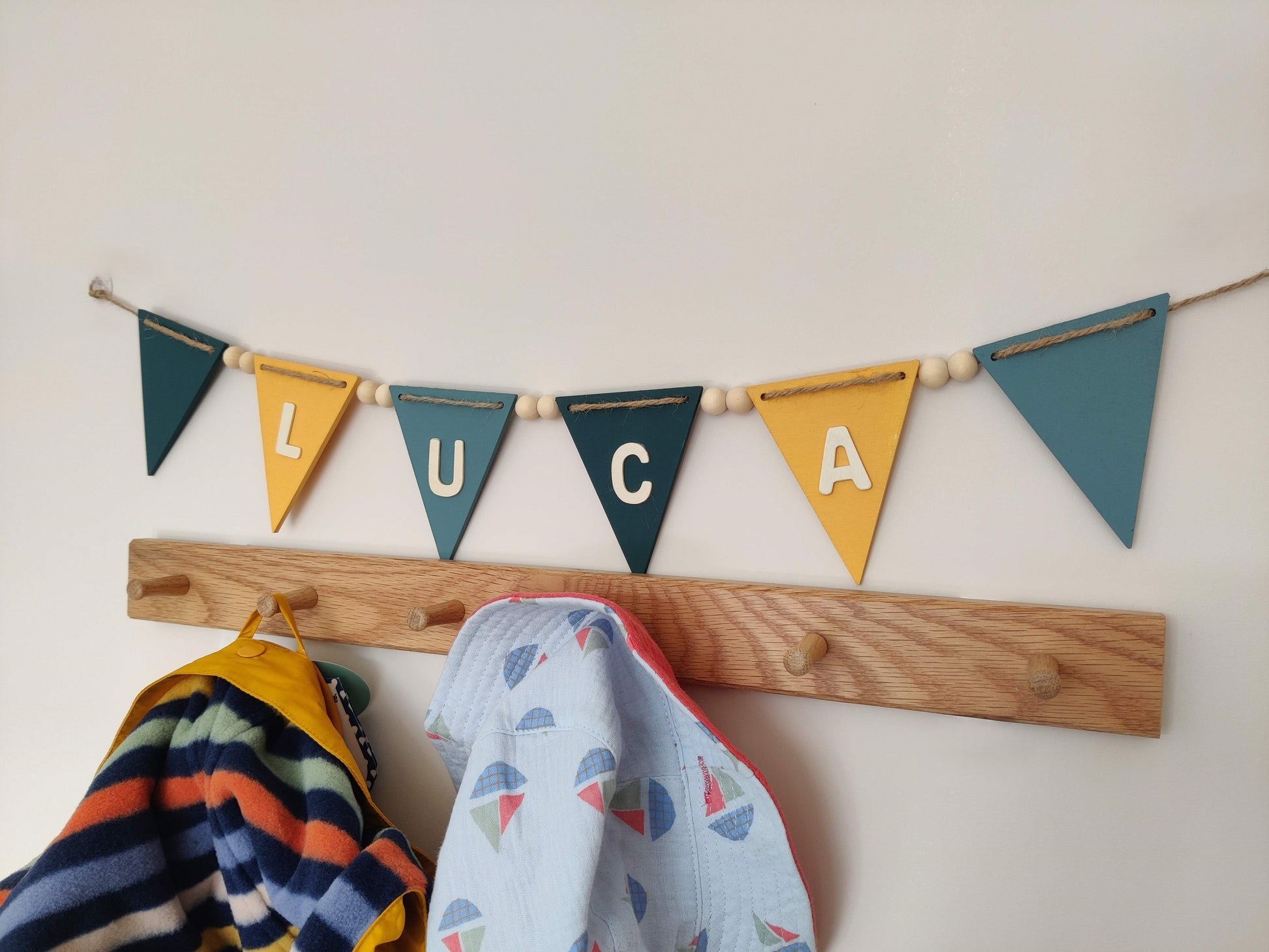 Blue and yellow coloured bunting with personalised name, wooden beads and natural twine